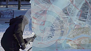 Undefined person making an ice skulpture. Winter activities concept