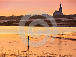 Undefined person skating on the frozen lake