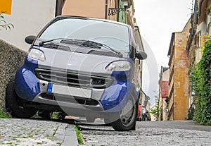 Undefined small car parked on narrow street. Czech Republic