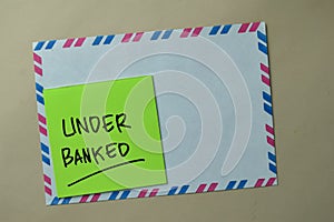 Under Banked write on sticky notes isolated on office desk