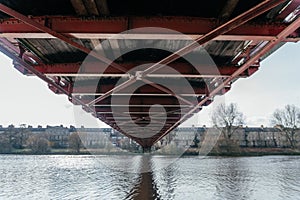 Under the Bridge: Architectural Perspective of Ironwork Over River