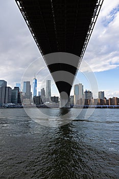 Under the Brooklyn Bridge over the East River with the Lower Manhattan New York City Skyline
