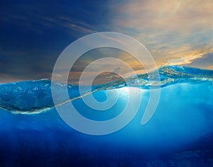 under clear water with beautiful dramatic sky above