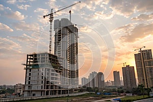 Under construction buildings during golden hour in Noida photo
