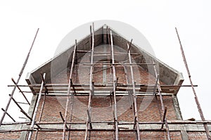 Under construction house with red brick wall