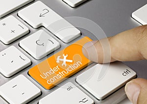 Under construction - Inscription on Orange Keyboard Key