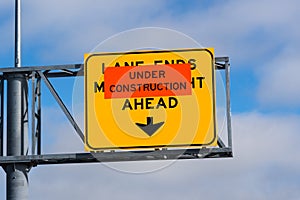 Under Construction `Lane Ends, Merge Right Ahead` sign posted on a freeway, California