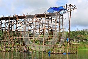 Under construction old wooden bridge Mon in Sangkhla Buri