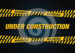 Under construction sign with caution and danger ribbon over pavement background