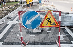 Under construction sign closeup. Road works sign for construction works in city street on a sidewalk road. Repairing