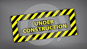 Under construction sign on gray background. Vector illustration for website. Under construction stamp with black and yellow stripe