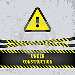 Under construction sign on gray ground background. Vector illustration for website. Under construction triangle with black and yel photo