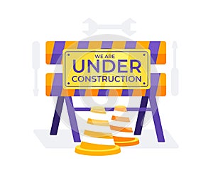 Under Construction sign with orange and white traffic cones and construction barriers