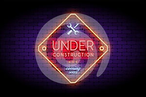 Under Construction sign in trendy neon style on the brick wall.