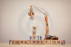 Under Construction sign on wooden tiles. Macro concept