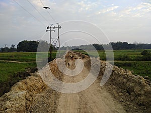 Under construction soil road and dogs in madhubani India photo