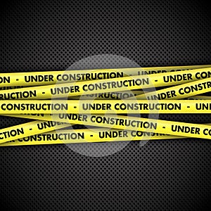 Under construction on tape on metal background