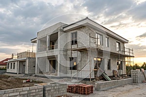 Under construction two-story house with concrete blocks photo