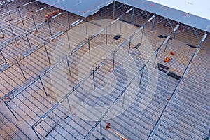 An under construction warehouse roof truss is made of metal frame steel framework and is located on the building site