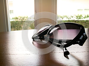 Under expose of fashion sunglasses on the wooden table