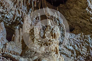 Under the ground. Beautiful view of stalactites and stalagmites in an underground cavern - New Athos Cave. Sacred