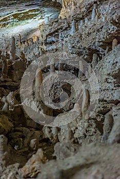 Under the ground. Beautiful view of stalactites and stalagmites in an underground cavern - New Athos Cave. Sacred