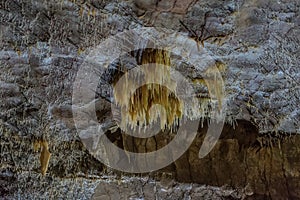 Under the ground. Beautiful view of stalactites and stalagmites in an underground cavern - New Athos Cave. Sacred