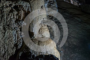 Under the ground. Beautiful view of stalactites and stalagmites in an underground cavern - New Athos Cave. Sacred