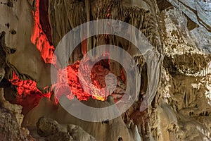 Under the ground. Beautiful view of stalactites and stalagmites in an underground cavern - New Athos Cave. Sacred