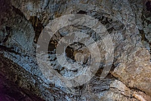 Under the ground. Beautiful view of stalactites and stalagmites in an underground cavern - New Athos Cave. Sacred