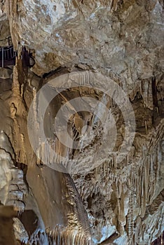 Under the ground. Beautiful view of stalactites and stalagmites in an underground cavern - New Athos Cave. Sacred