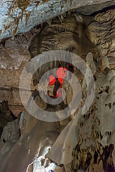 Under the ground. Beautiful view of stalactites and stalagmites in an underground cavern - New Athos Cave. Sacred