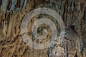 Under the ground. Beautiful view of stalactites and stalagmites in an underground cavern - New Athos Cave. Sacred