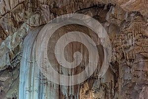 Under the ground. Beautiful view of stalactites and stalagmites in an underground cavern - New Athos Cave. Sacred