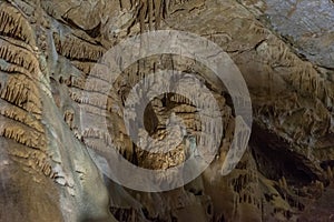 Under the ground. Beautiful view of stalactites and stalagmites in an underground cavern - New Athos Cave. Sacred