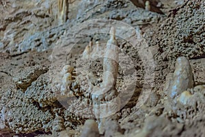 Under the ground. Beautiful view of stalactites and stalagmites in an underground cavern - New Athos Cave. Sacred