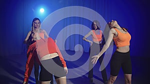 Under the guidance of instructor, a group of women engage dance on high heels.