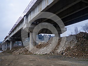 under the overpass. Terrible deserted place. Danger. Gloomy atmosphere. Industrial zone photo