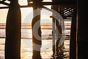 Under the pier at sunset