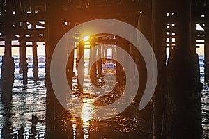 Under the pier at sunset