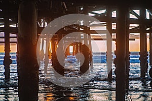 Under the pier at sunset