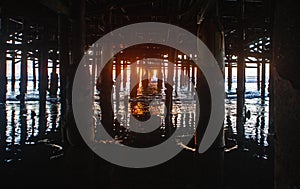 Under the pier at sunset