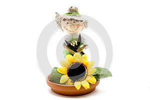 Under plate with straw doll and sunflower