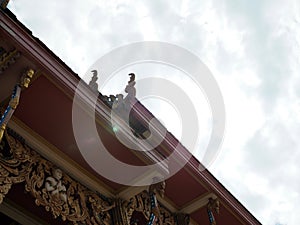 Under the roof of a Thai temple church On the background is the sky