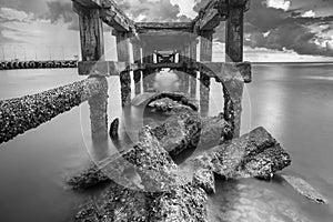 Under The ruins of Jetty, Photo long exposure, Seascape of thailand.Black and white photo.