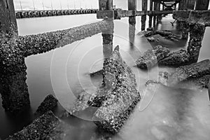 Under The ruins of Jetty, Photo long exposure, Seascape of thailand.Black and white photo.