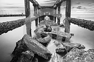 Under The ruins of Jetty, Photo long exposure, Seascape of thailand.Black and white photo.