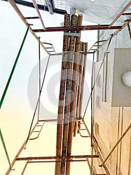 under several sets of scaffolding during building repairs in the morning