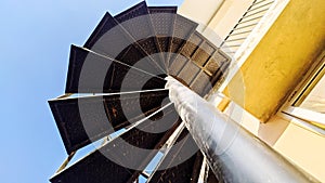 Under spiral stairs with blue sky