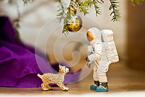 Under the tree. Lynx looking at an astronaut. Disco ball. Toy minifigures.